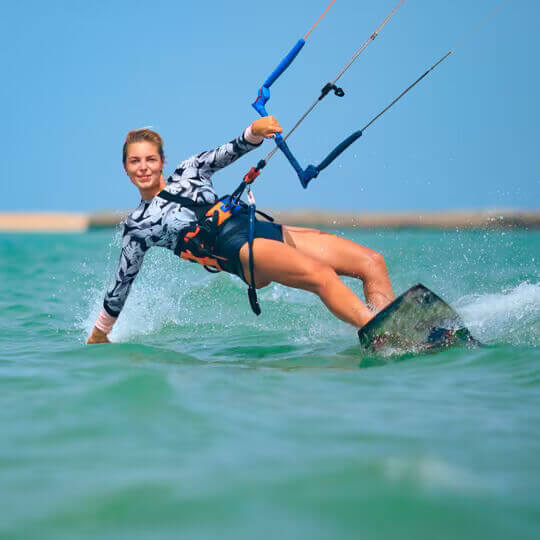 Woman kiteboarding on the ocean